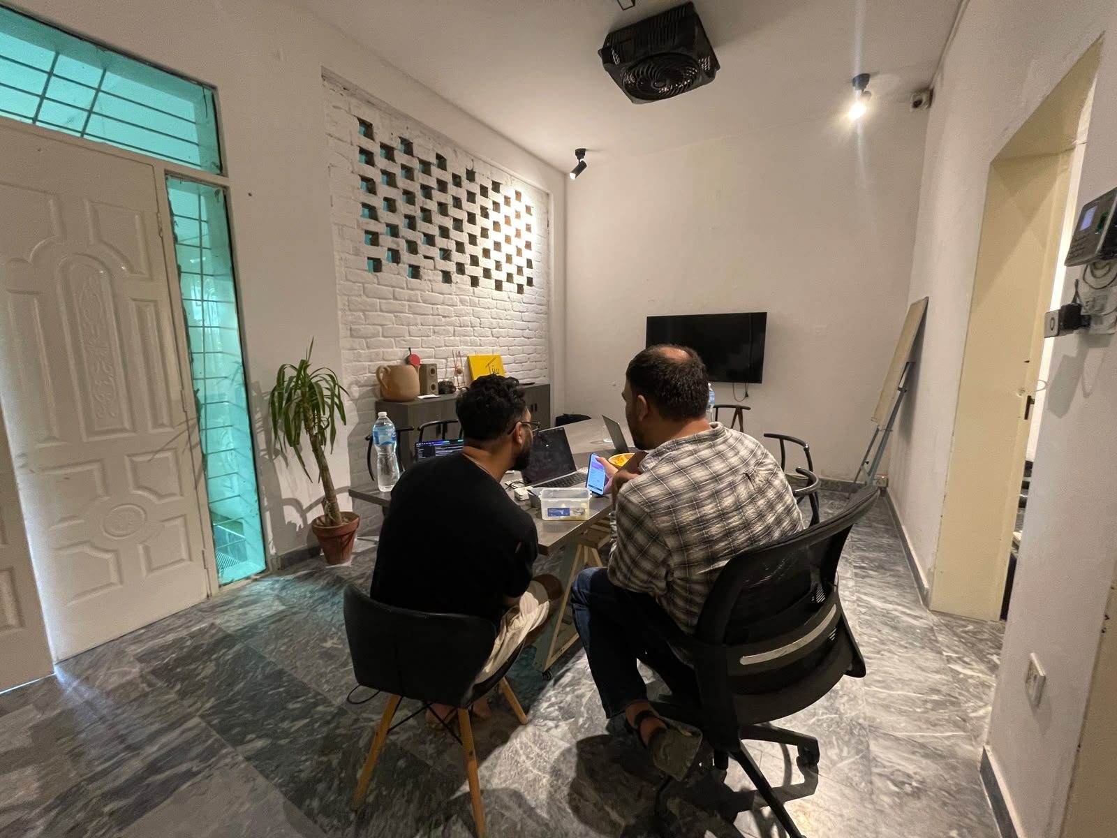 Students working on laptops in Rukh Foundation's tech space